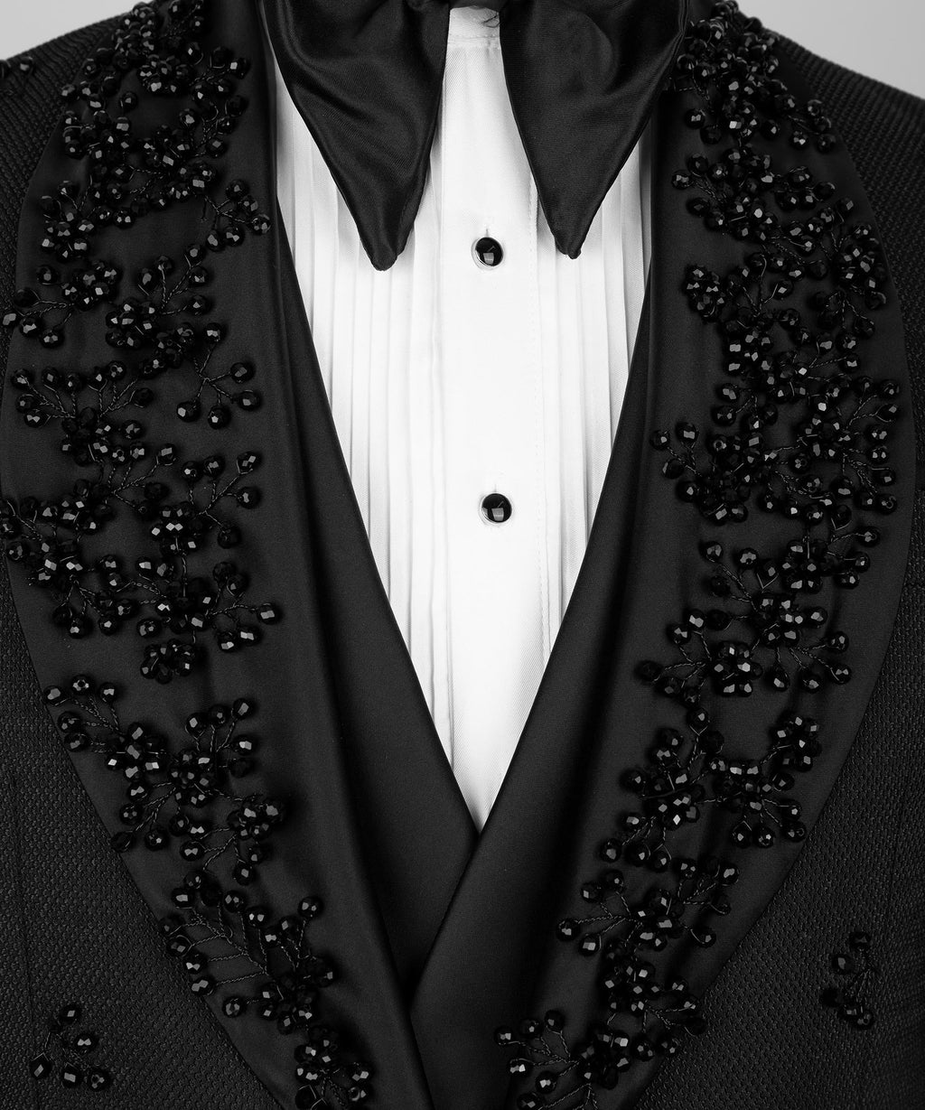 Close-up of black tuxedo lapels with crystal jeweled detailing and bow-tie collar