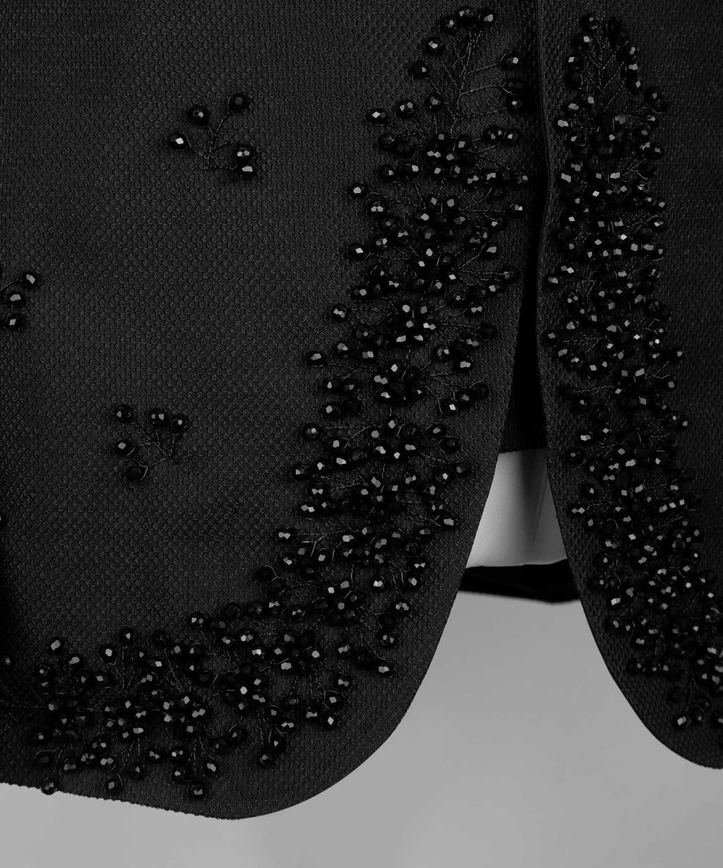 Black tuxedo jacket sleeve and lower front with crystal jeweled trim