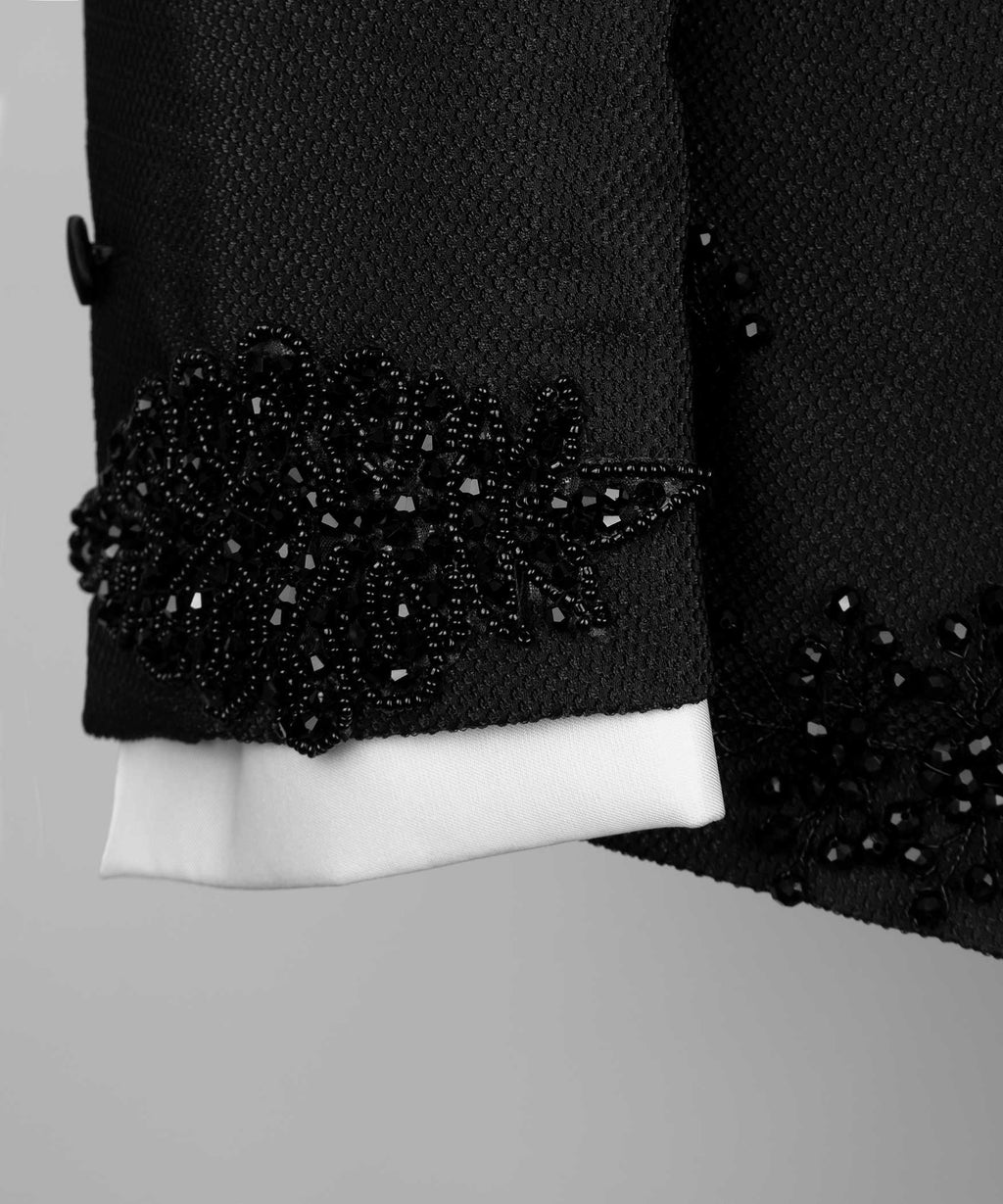 Black tuxedo jacket cuff with crystal jeweled band and white shirt cuff