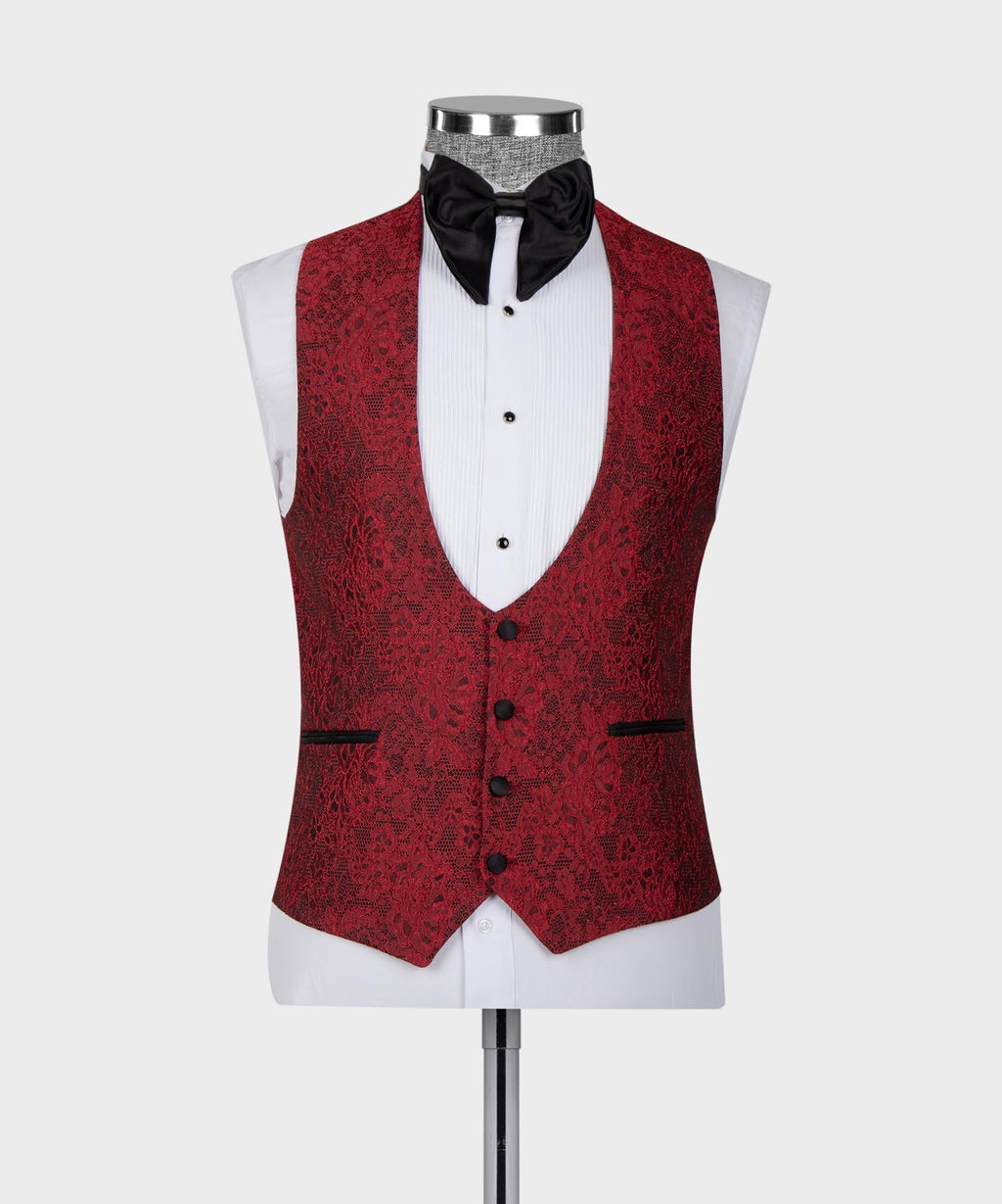 Red patterned tuxedo vest with black satin lapels and black bow tie over white shirt