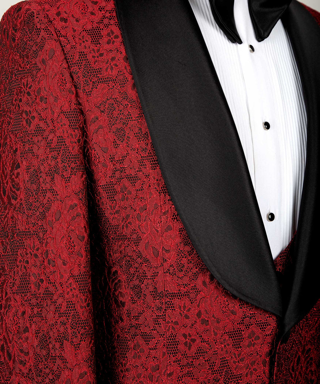 Close-up of red patterned tuxedo lapel with black satin trim and buttoned shirtfront