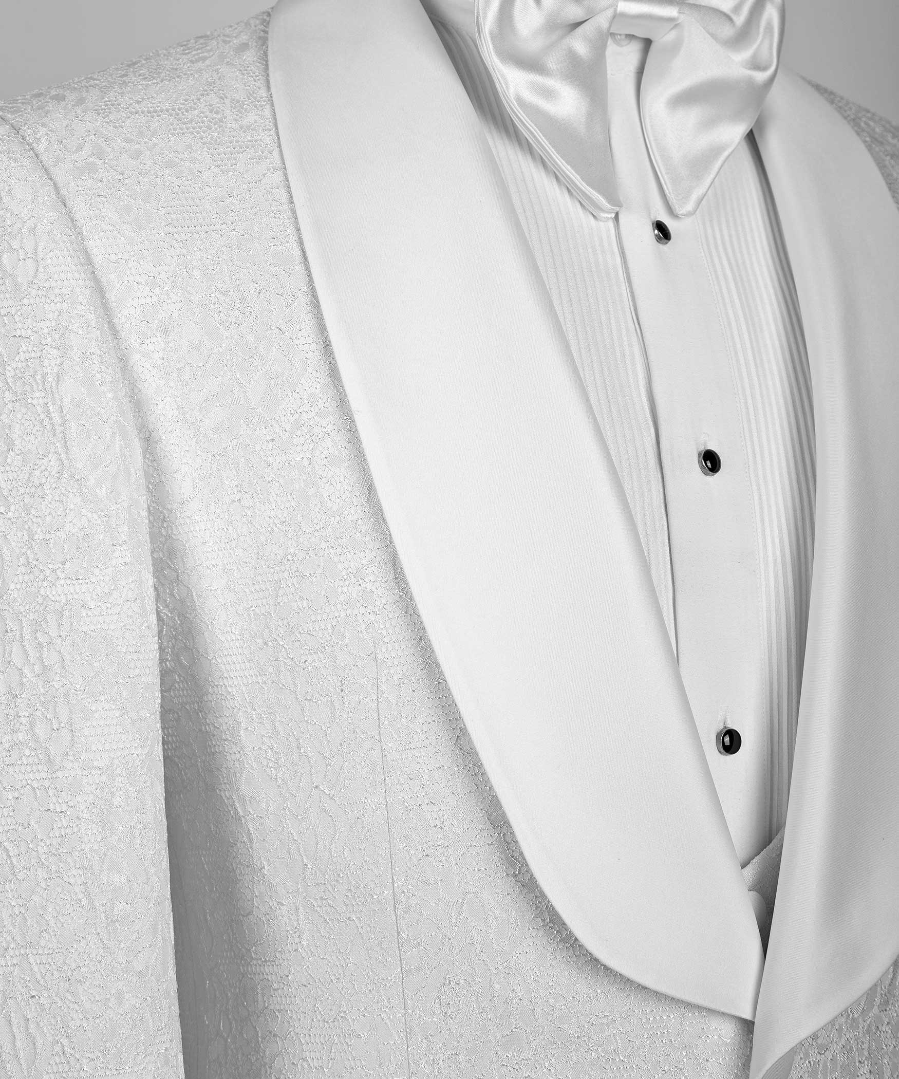 Close-up of white satin-collar shirt with black buttons and pin-tuck stripes