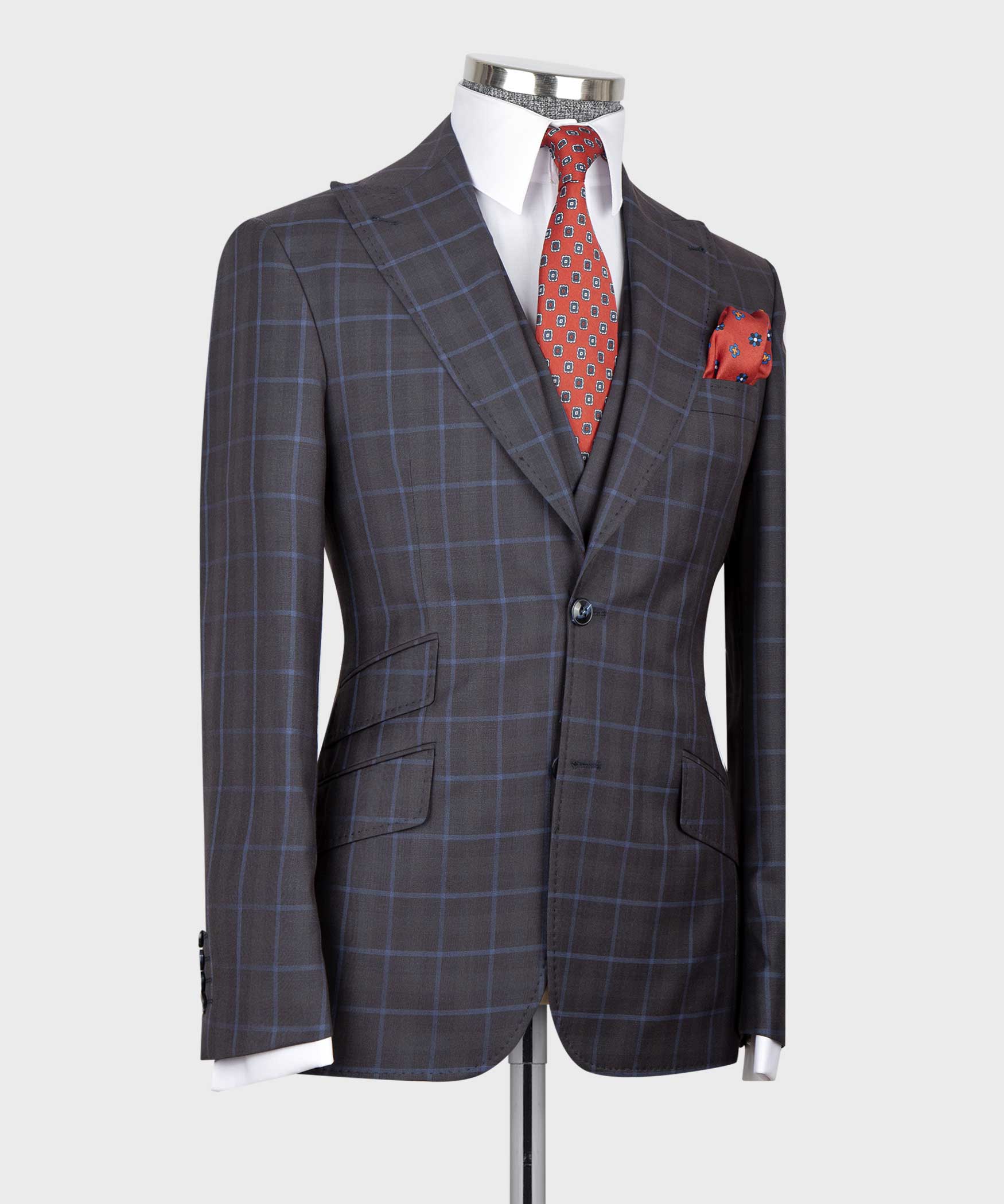 Dark plaid dress vest suit with red patterned tie and folded red pocket square