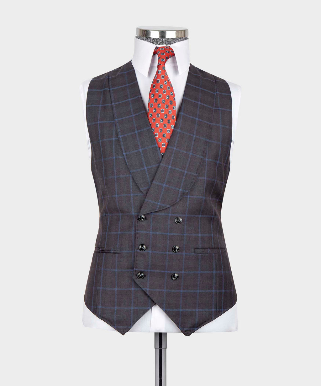 Dark checkered suit vest front with red patterned tie and matching pocket square