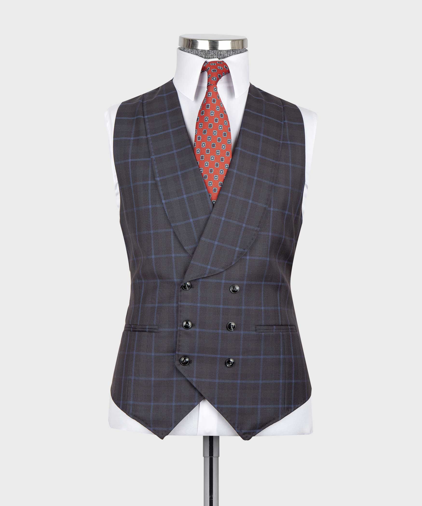 Dark checkered suit vest front with red patterned tie and matching pocket square