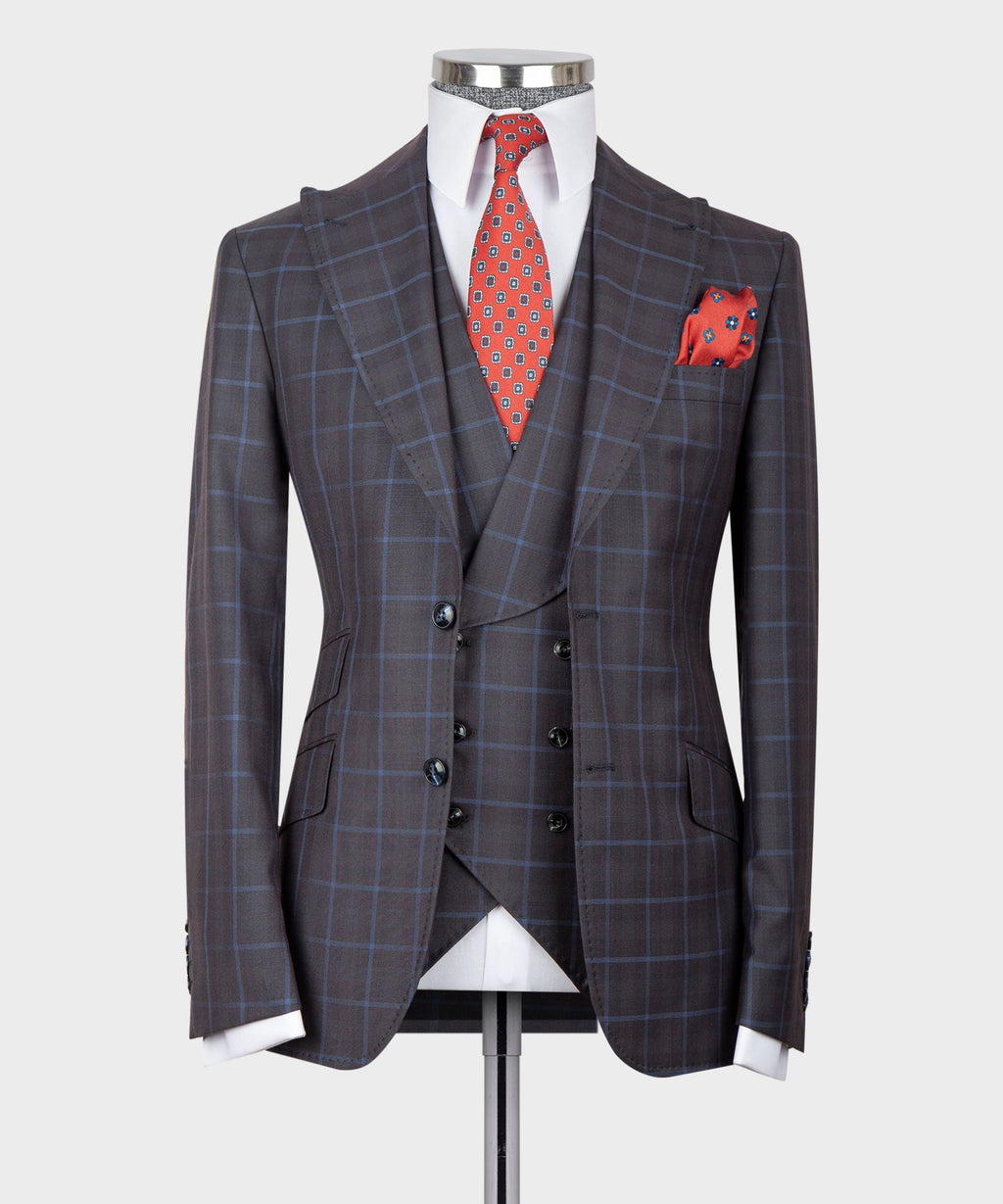 Dark checkered three-piece vest suit with red patterned tie and pocket square