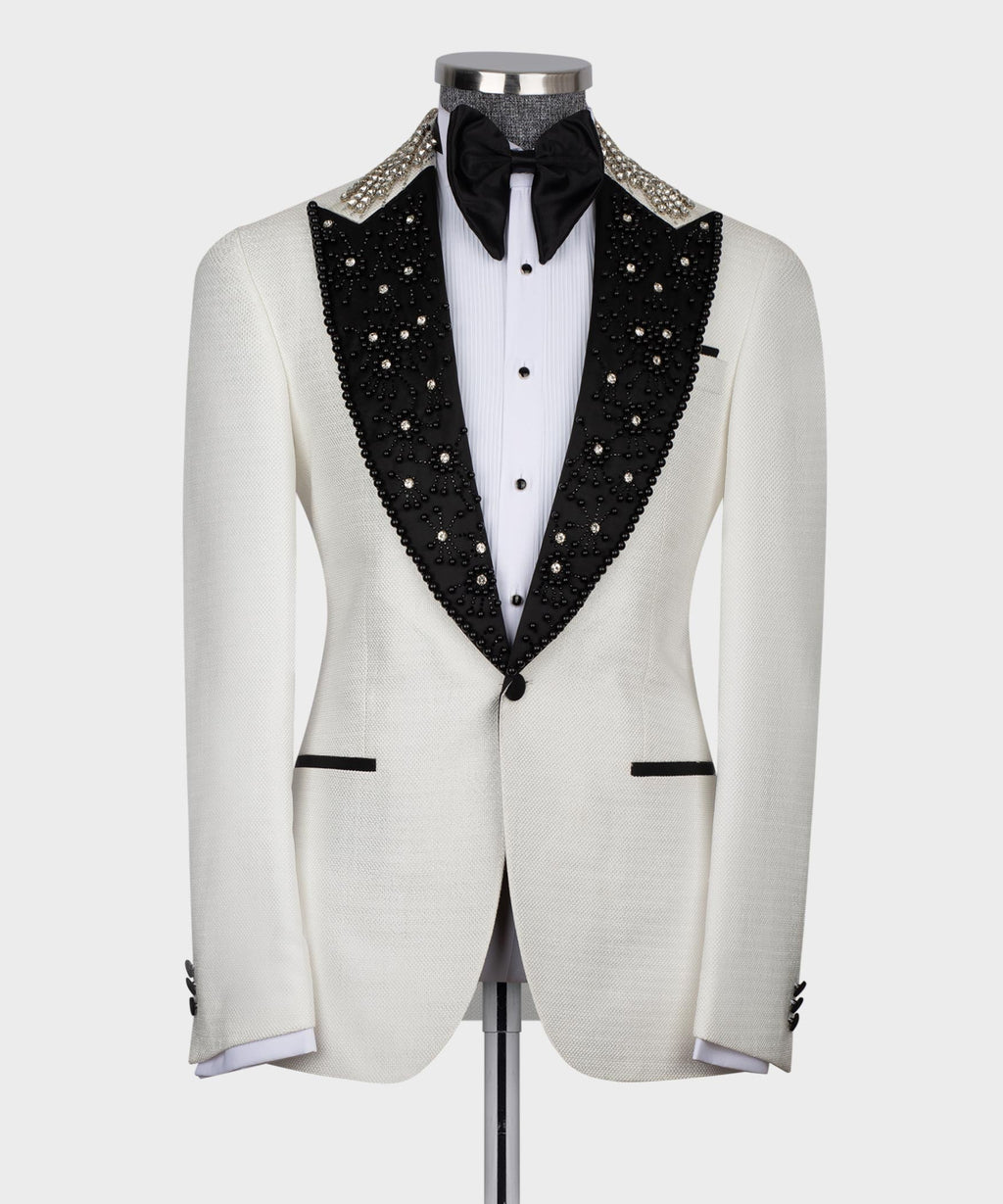 White tuxedo jacket with black jeweled lapels, black bow tie, white shirt