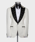 White tuxedo jacket with black jeweled lapels, black bow tie, white shirt