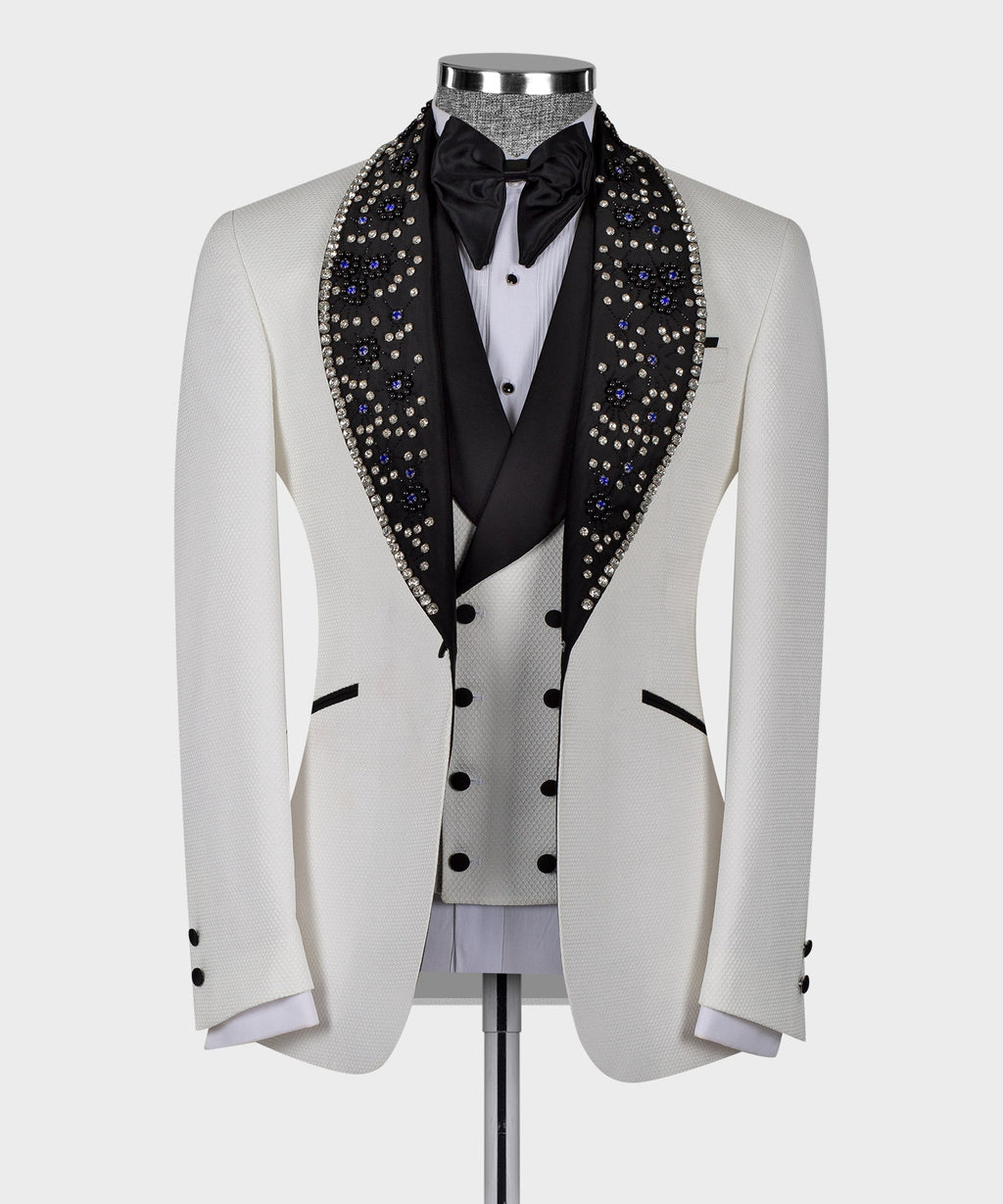 White tuxedo jacket with black satin bow tie and blue crystal gem trim lapels