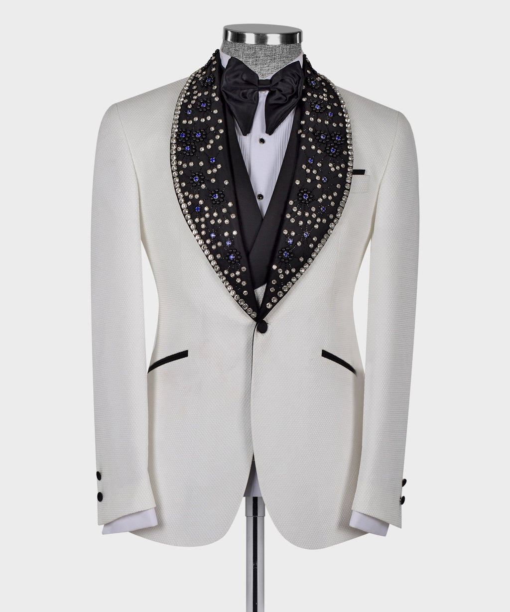White tuxedo jacket with black shawl-style lapels and gem-studded crystal embellishment