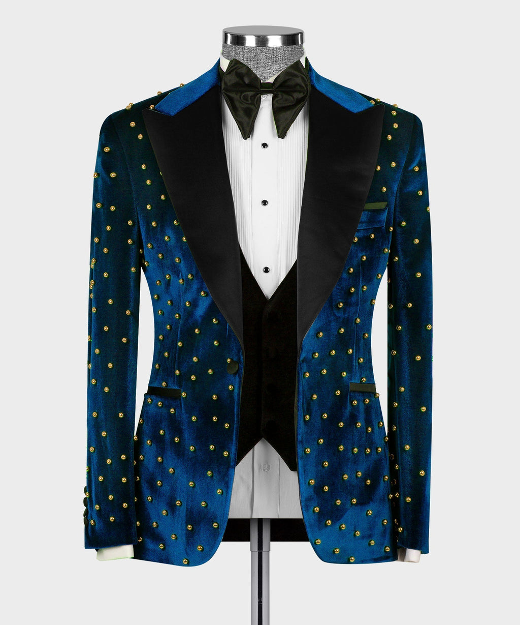 Blue velvet tuxedo jacket with black lapels, gold studs, and matching waistcoat