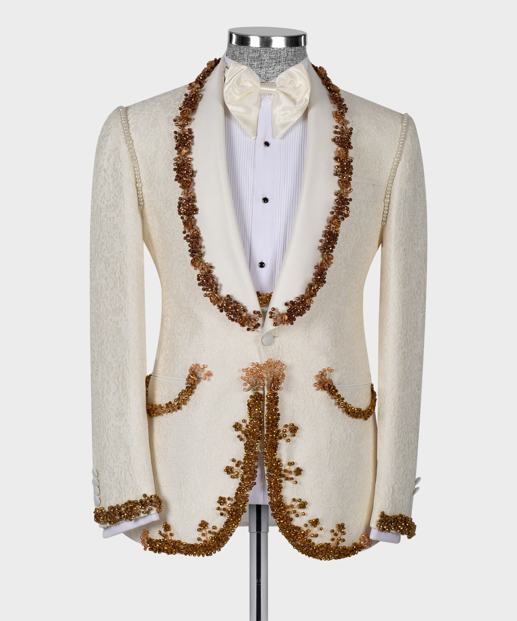 Cream tuxedo jacket with long gold bead garland trim and bow tie over white shirt