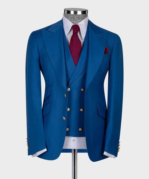 Blue business suit jacket with gold buttons, red patterned tie, and matching pocket square