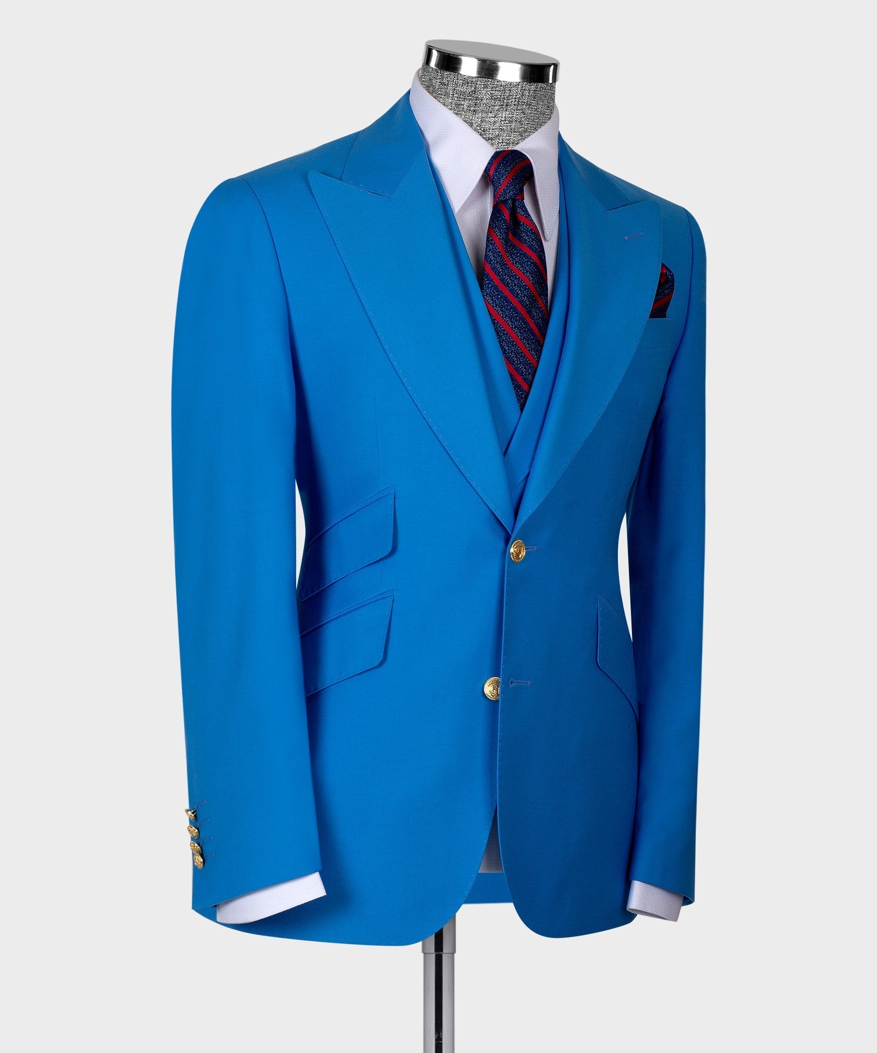 Light blue suit jacket with folded lapels, gold buttons, and striped necktie