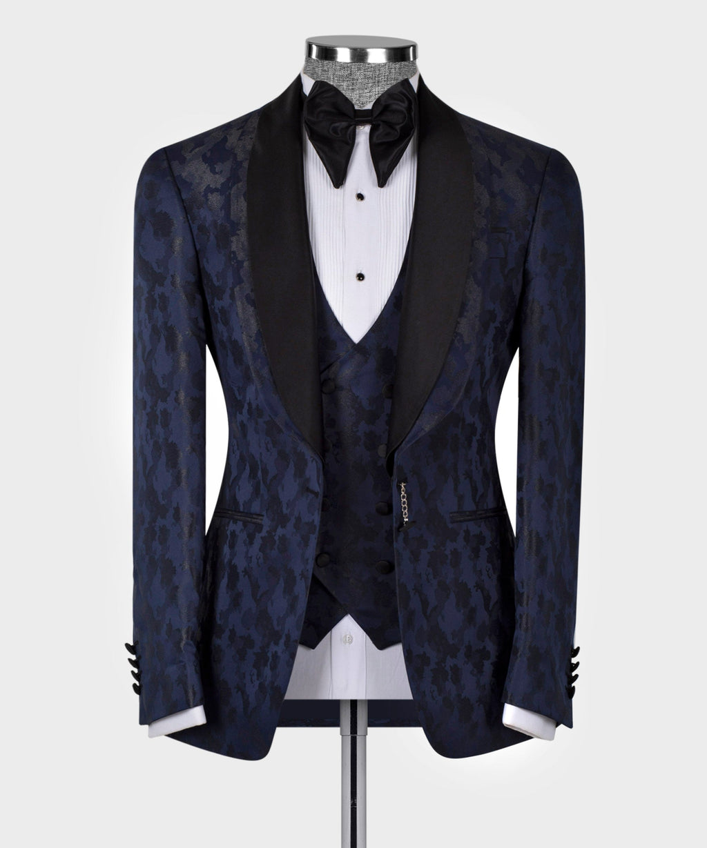Navy tuxedo jacket, black lapels, patterned fabric sheen; bow tie and white vest