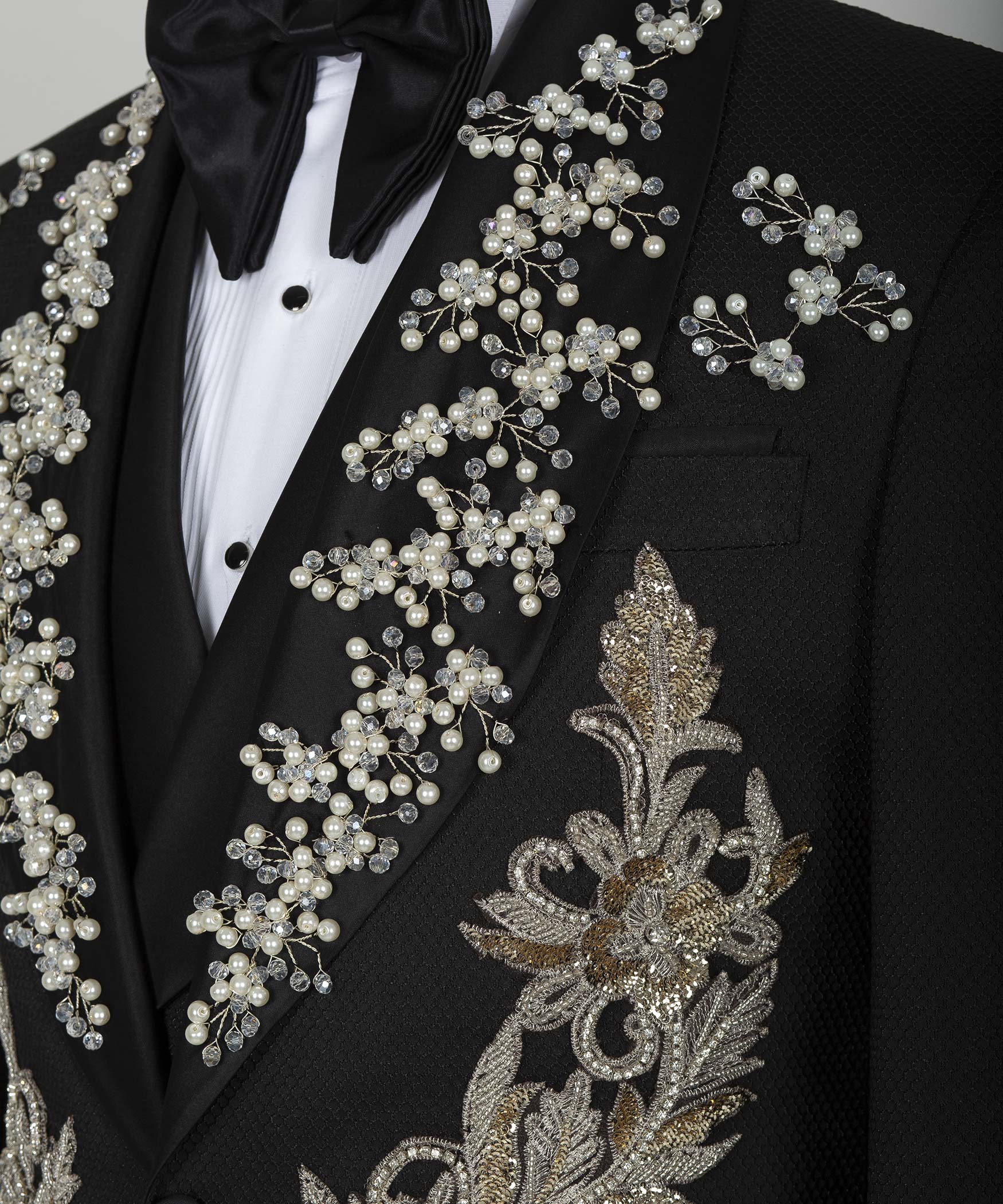 Black tuxedo jacket sleeve and chest detail with pearl-and-crystal floral embroidery