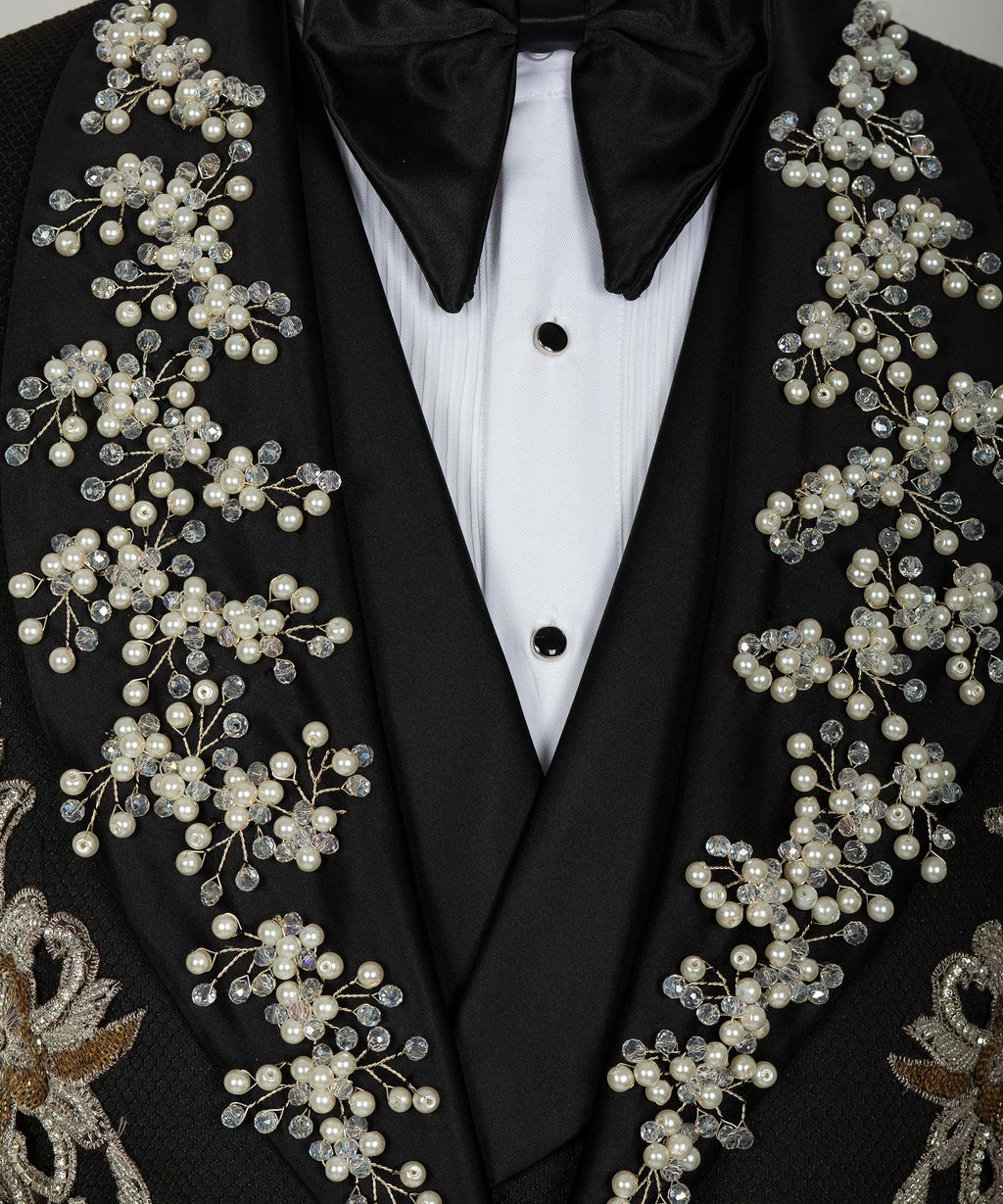 Close-up of black tuxedo jacket lapels with pearl, crystal, and gold floral appliqués