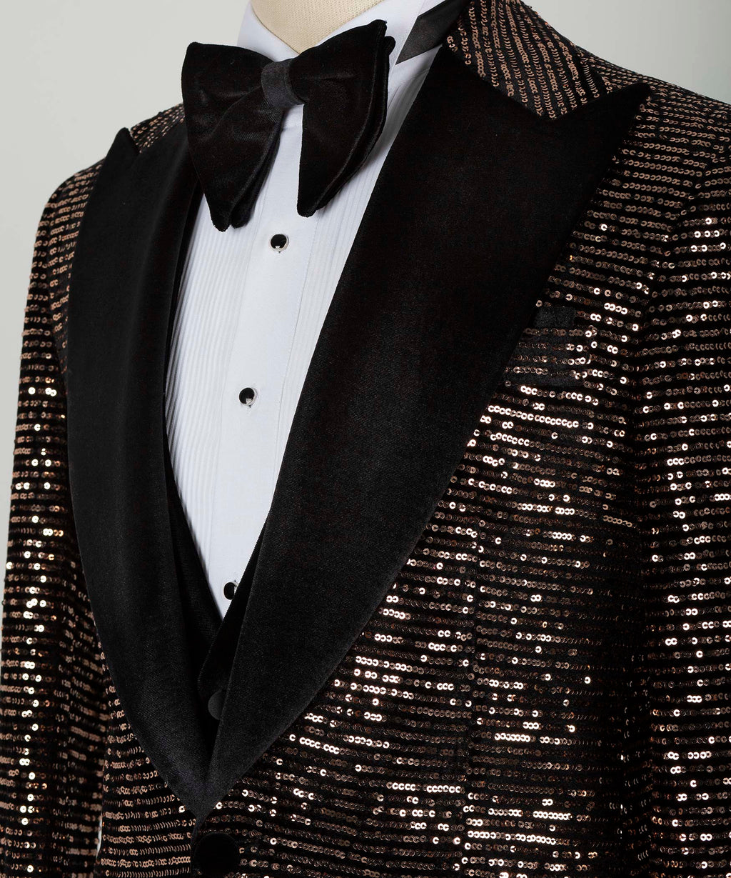 Close-up of tuxedo bow tie, white shirt buttons, and copper-black sequin jacket lapel