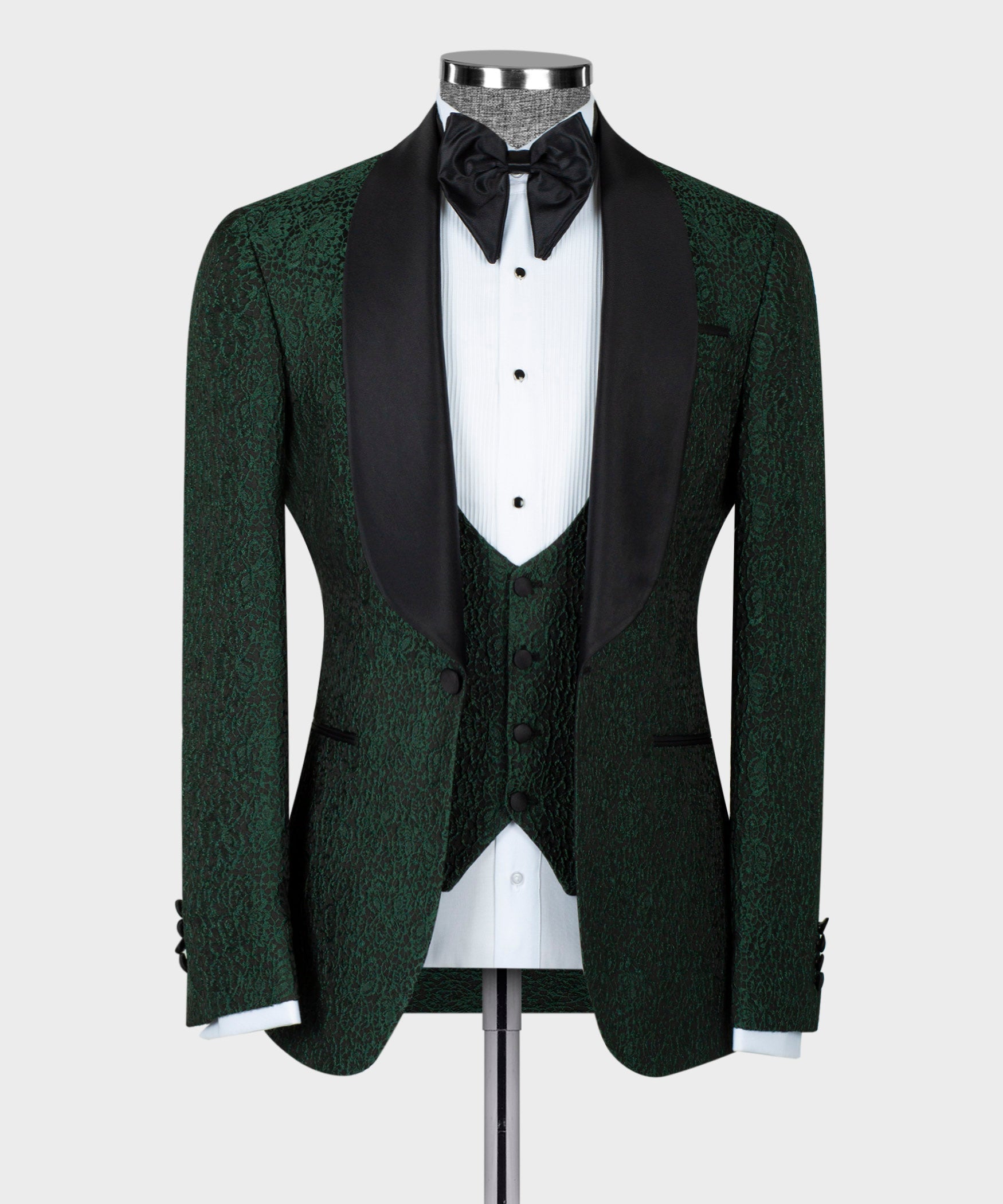Green tuxedo jacket with black satin lapels, bow tie, and patterned waistcoat