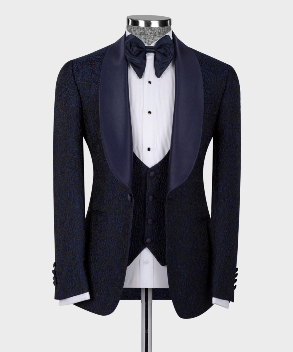 Blue satin-collar tuxedo suit on mannequin: bow tie, vest, satin-trim lapels.