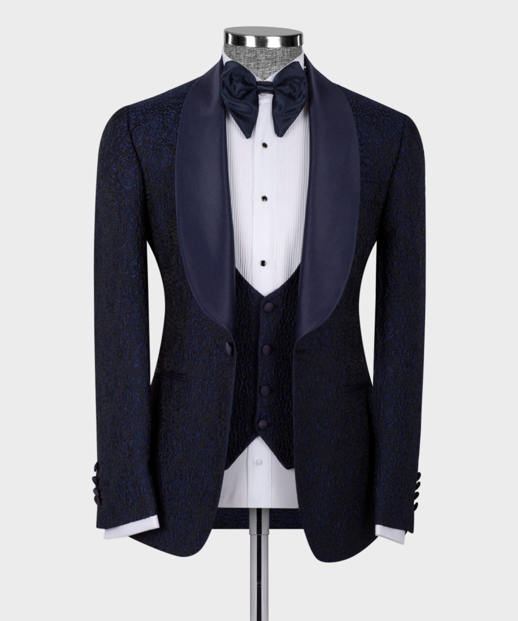 Blue satin-collar tuxedo suit on mannequin: bow tie, vest, satin-trim lapels.