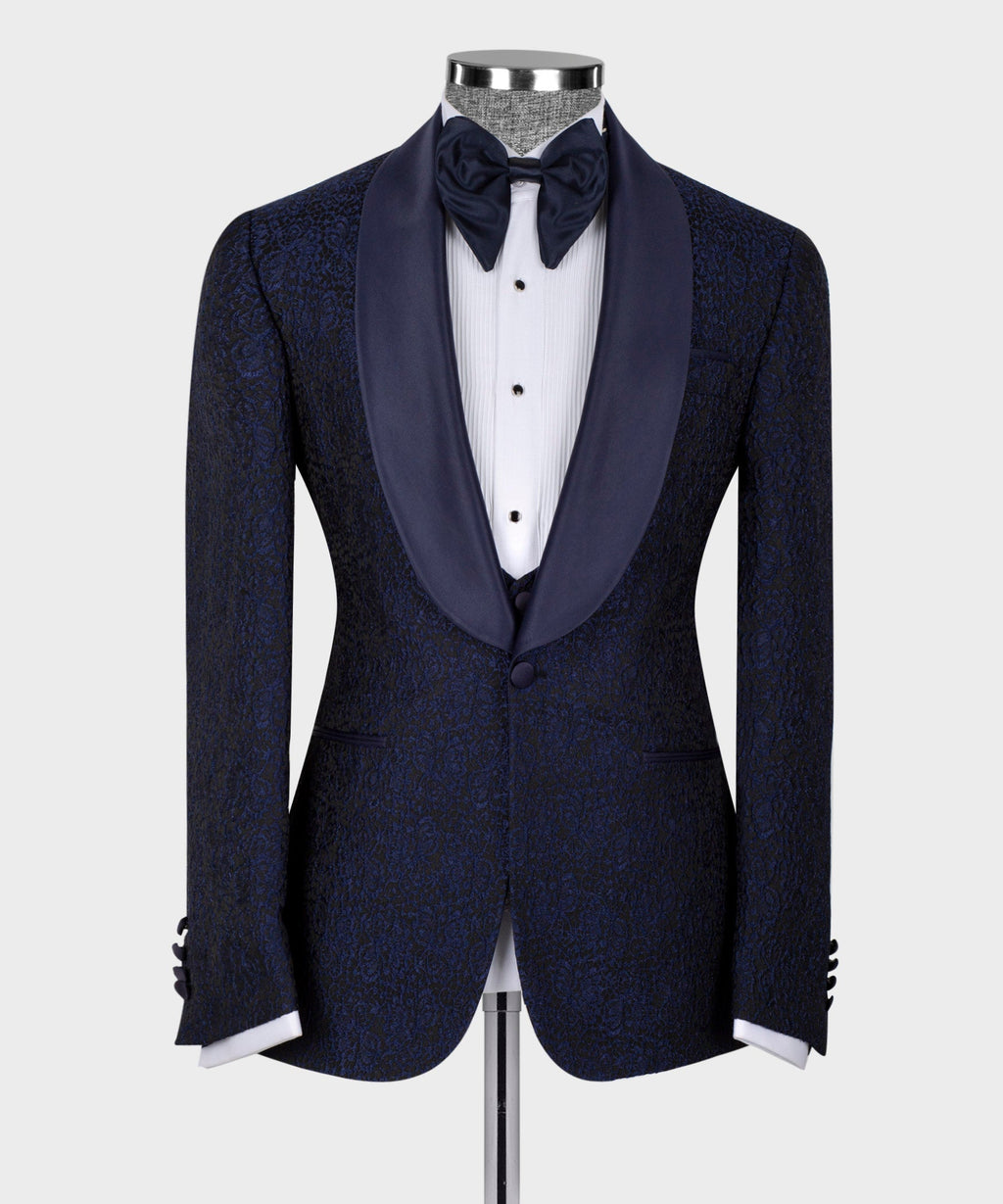 Dark tuxedo jacket with satin lapels and black bow tie; three-piece vest and shirt.