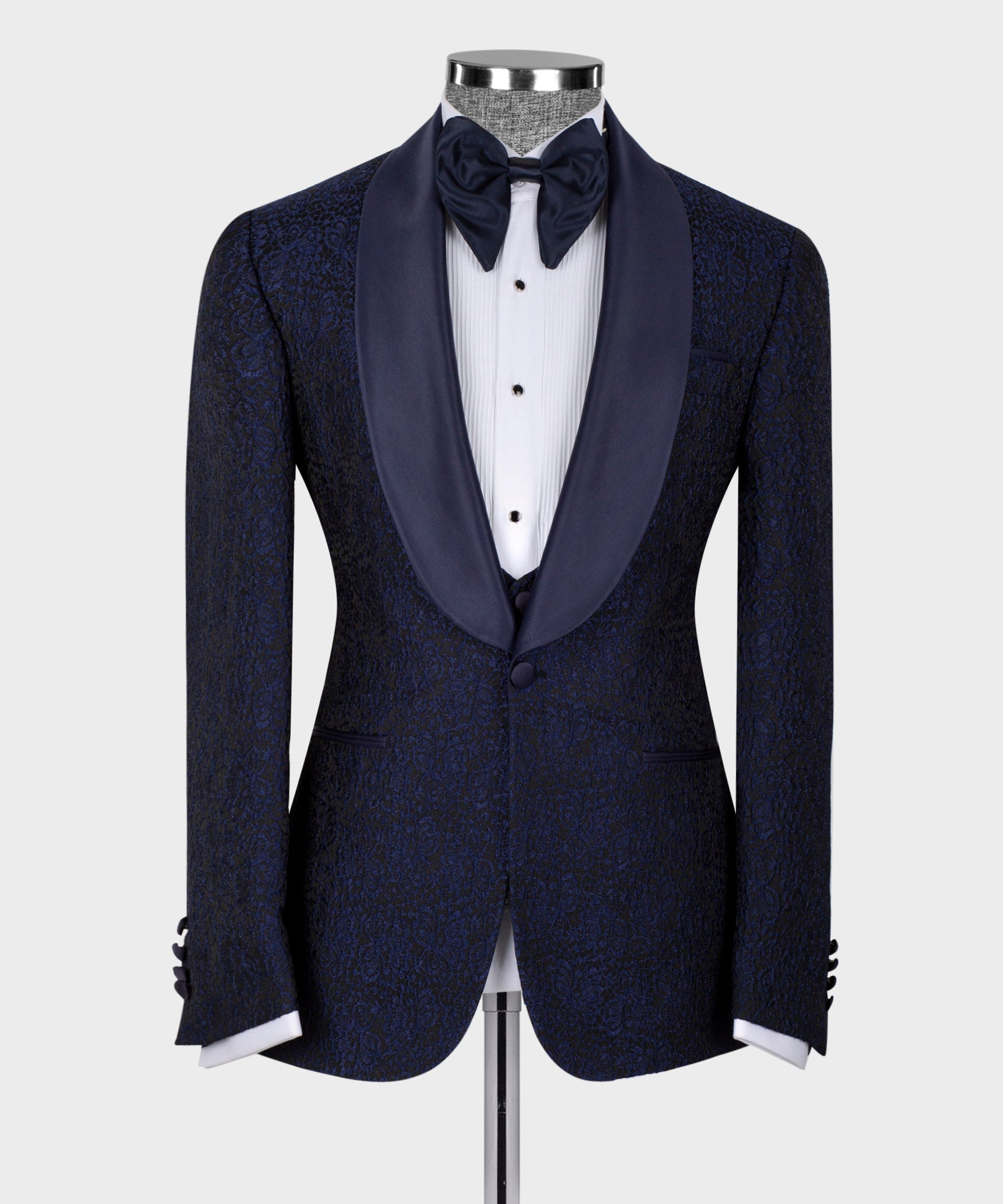 Dark tuxedo jacket with satin lapels and black bow tie; three-piece vest and shirt.