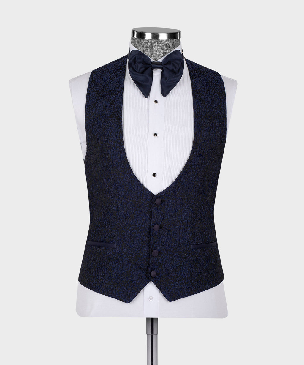 Dark three-piece tuxedo suit vest and jacket with satin collar trim on mannequin.