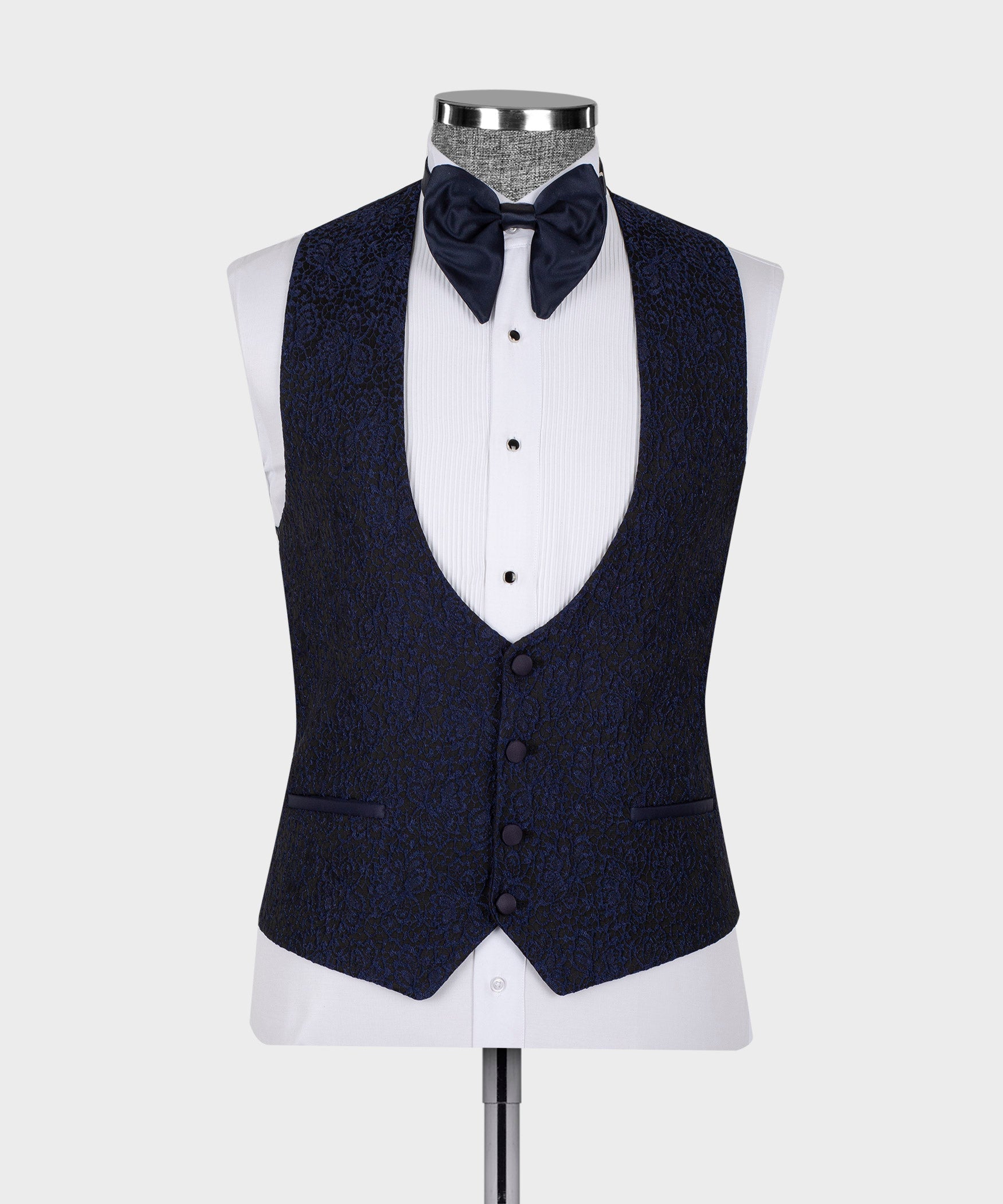 Dark three-piece tuxedo suit vest and jacket with satin collar trim on mannequin.