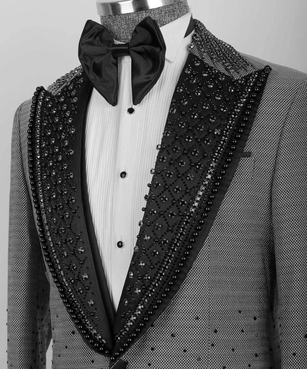 Close-up gray tuxedo lapels with black beaded trim over white shirt and black bow tie