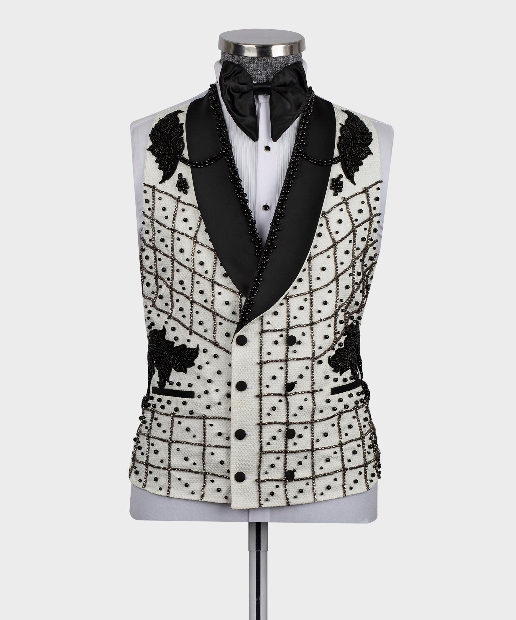 White tuxedo jacket with black vest panels, bow tie, and crystal bead grid trim