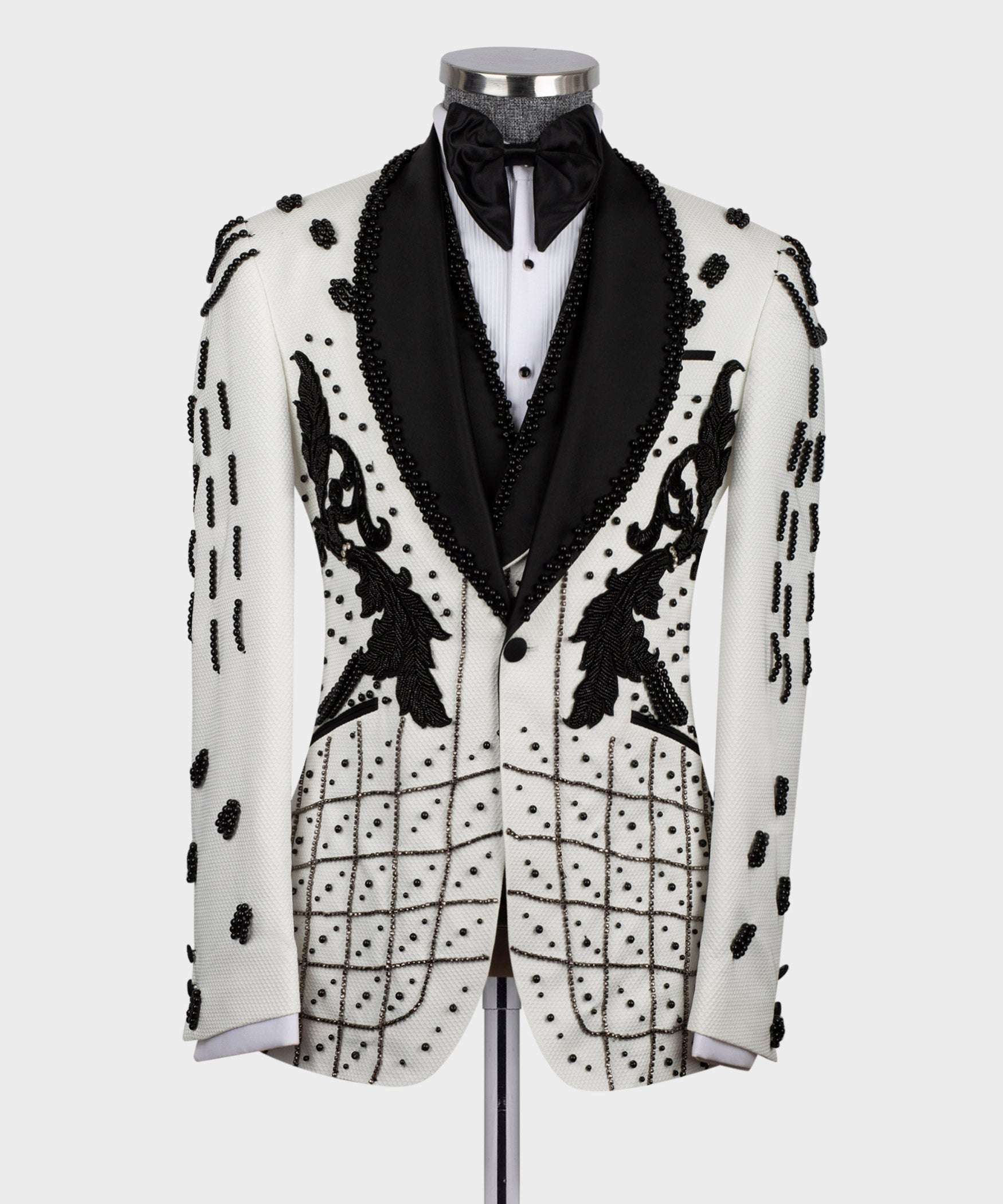 Front view white tuxedo jacket with black bow tie and beaded floral appliqués