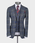 Dark gray 3-piece suit: blue windowpane jacket, matching vest, red patterned tie