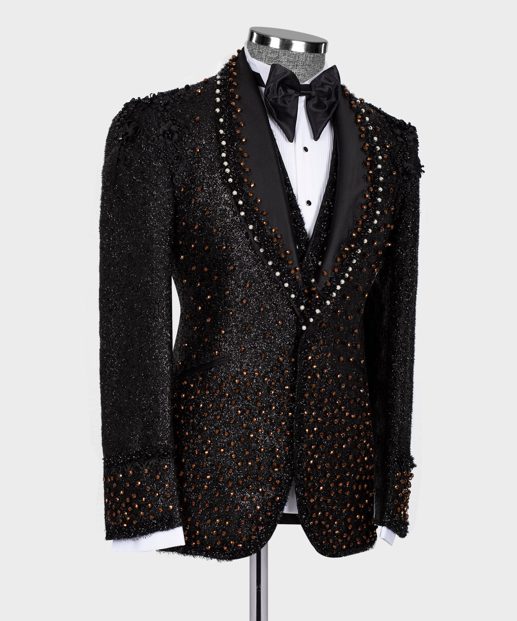 Black tuxedo jacket with beaded lapel trim and satin bow tie, angled view