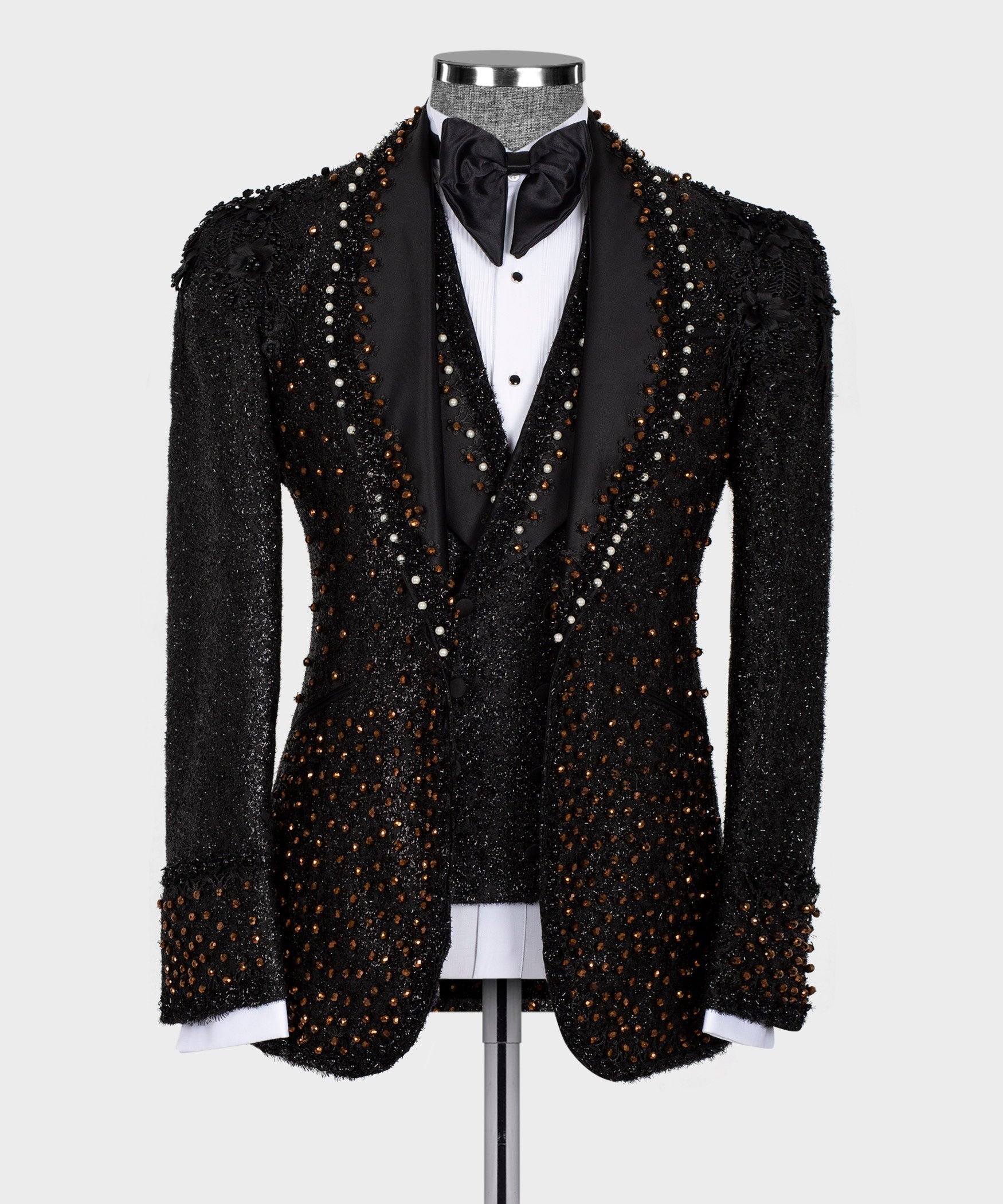 Black beaded tuxedo jacket with satin bow tie and white shirt panel on mannequin