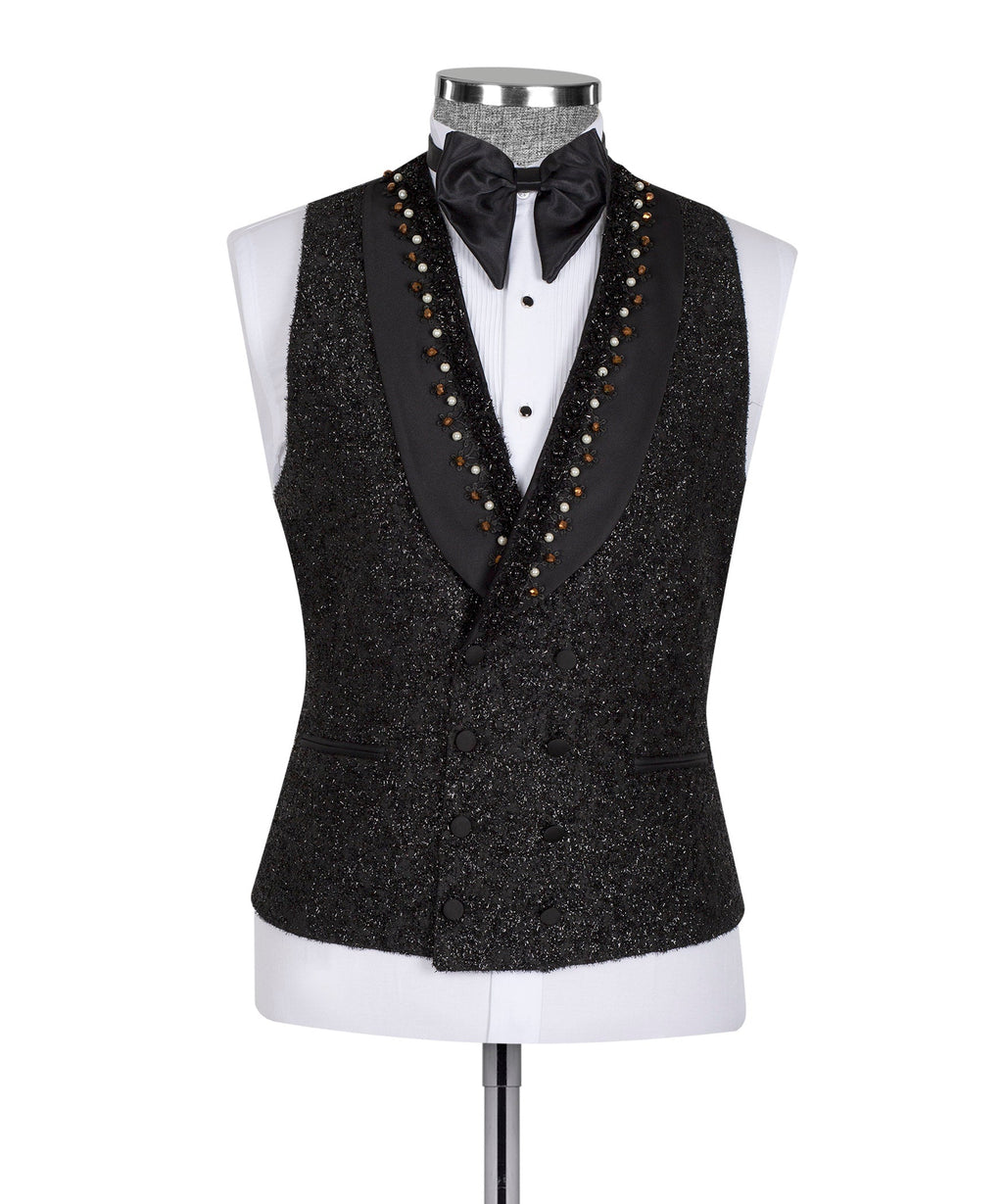 Black tuxedo vest with satin bow tie and beaded trim over white shirt on mannequin