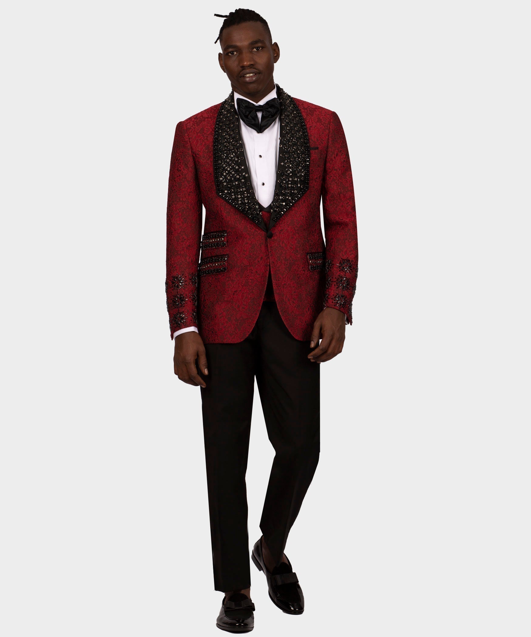 Men’s red tuxedo jacket with black satin vest, bow tie, white shirt, and black trousers