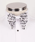 Koss Atelier white silk bow tie with silver spike embellishments, worn on a white pleated dress shirt.