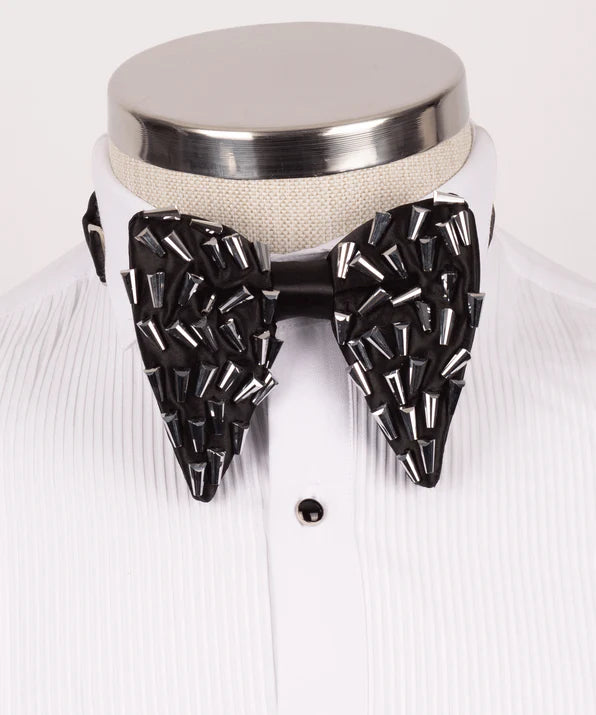 Koss Atelier black silk bow tie adorned with metallic silver spikes, displayed on a white tuxedo shirt.