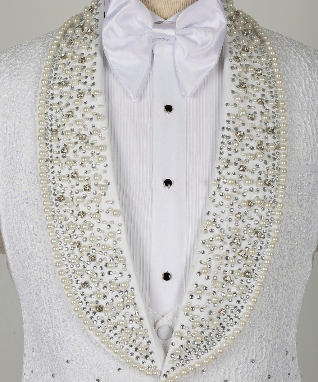 Close-up white tuxedo shirt front with bow tie and gold gem-studded lapels