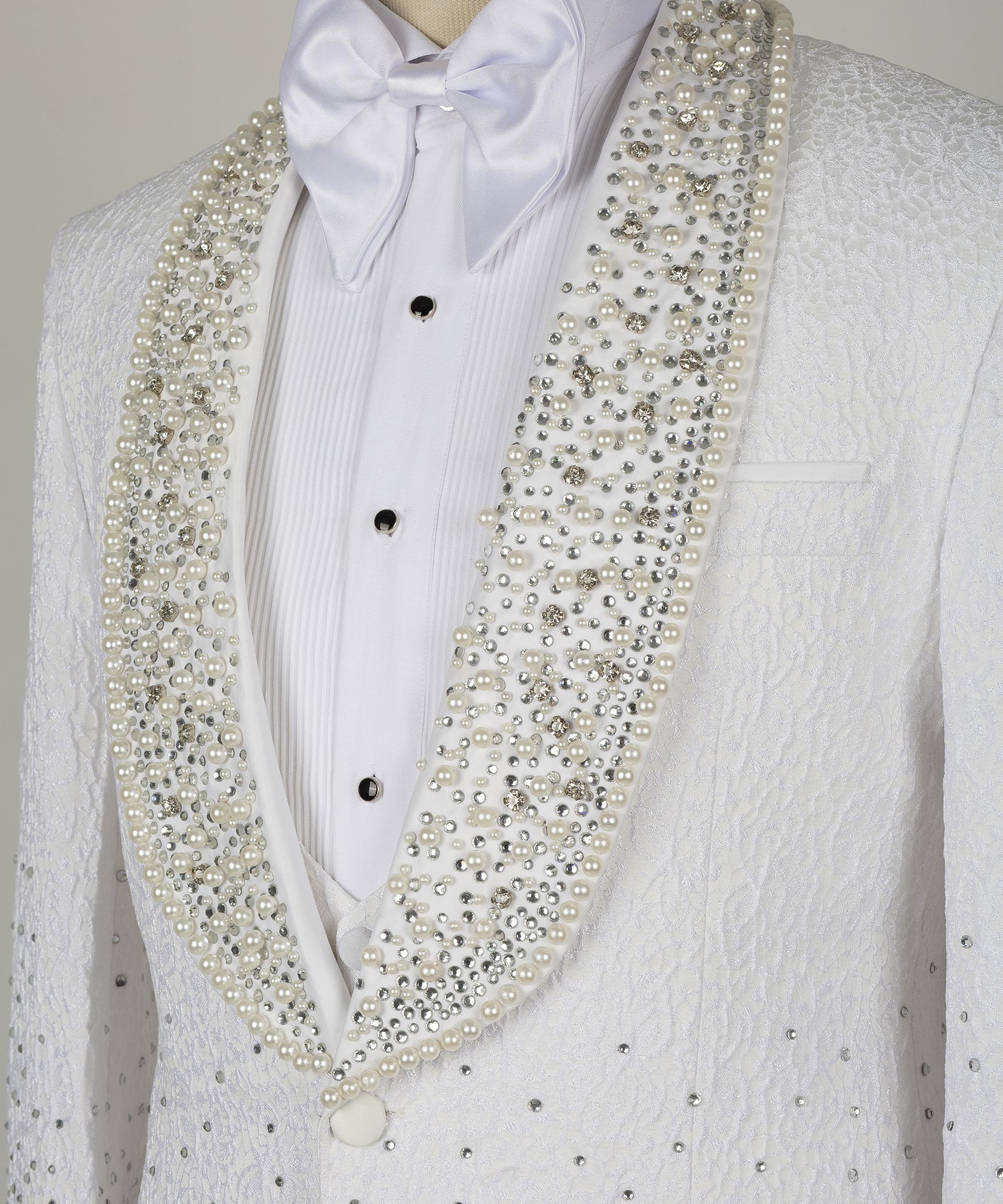 White tuxedo shirt placket and gold jeweled lapels with black button details