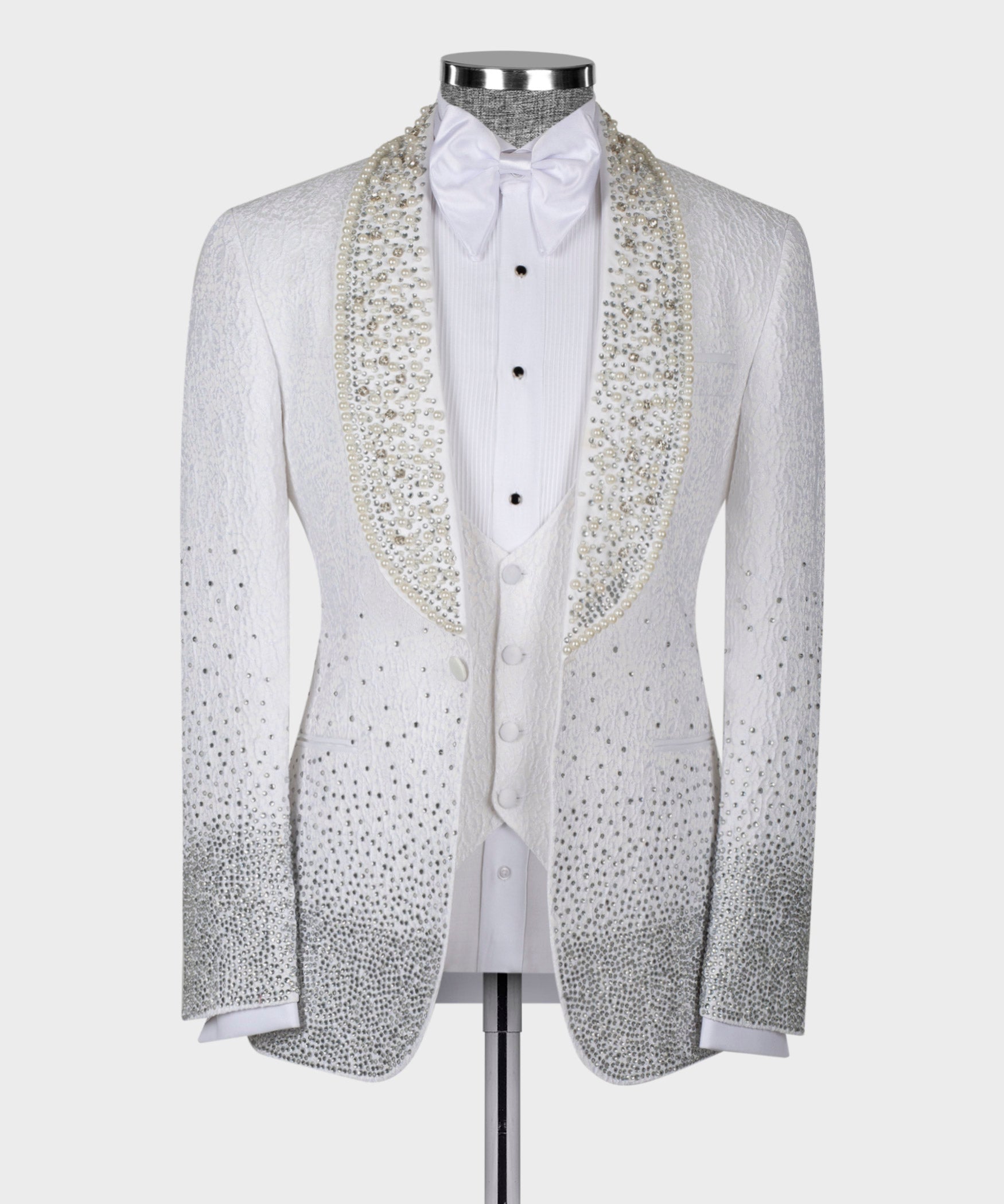 White tuxedo jacket front with bow tie, gold embellished lapels, button placket