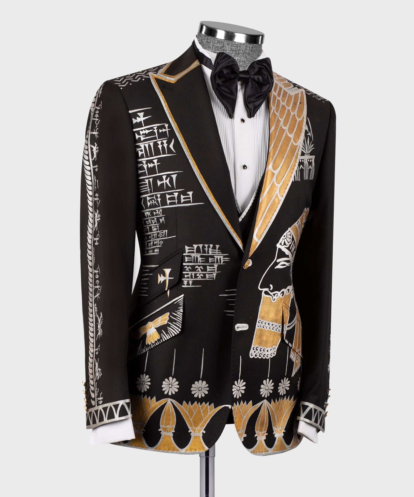 Black tuxedo 3-piece suit: satin bow tie, white vest, gold-and-white embroidered jacket