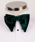 Koss Atelier dark green velvet bow tie with oversized, pointed ends worn on a white pleated dress shirt.