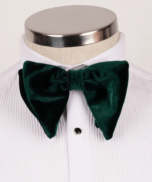 Koss Atelier dark green velvet bow tie with oversized, pointed ends worn on a white pleated dress shirt.