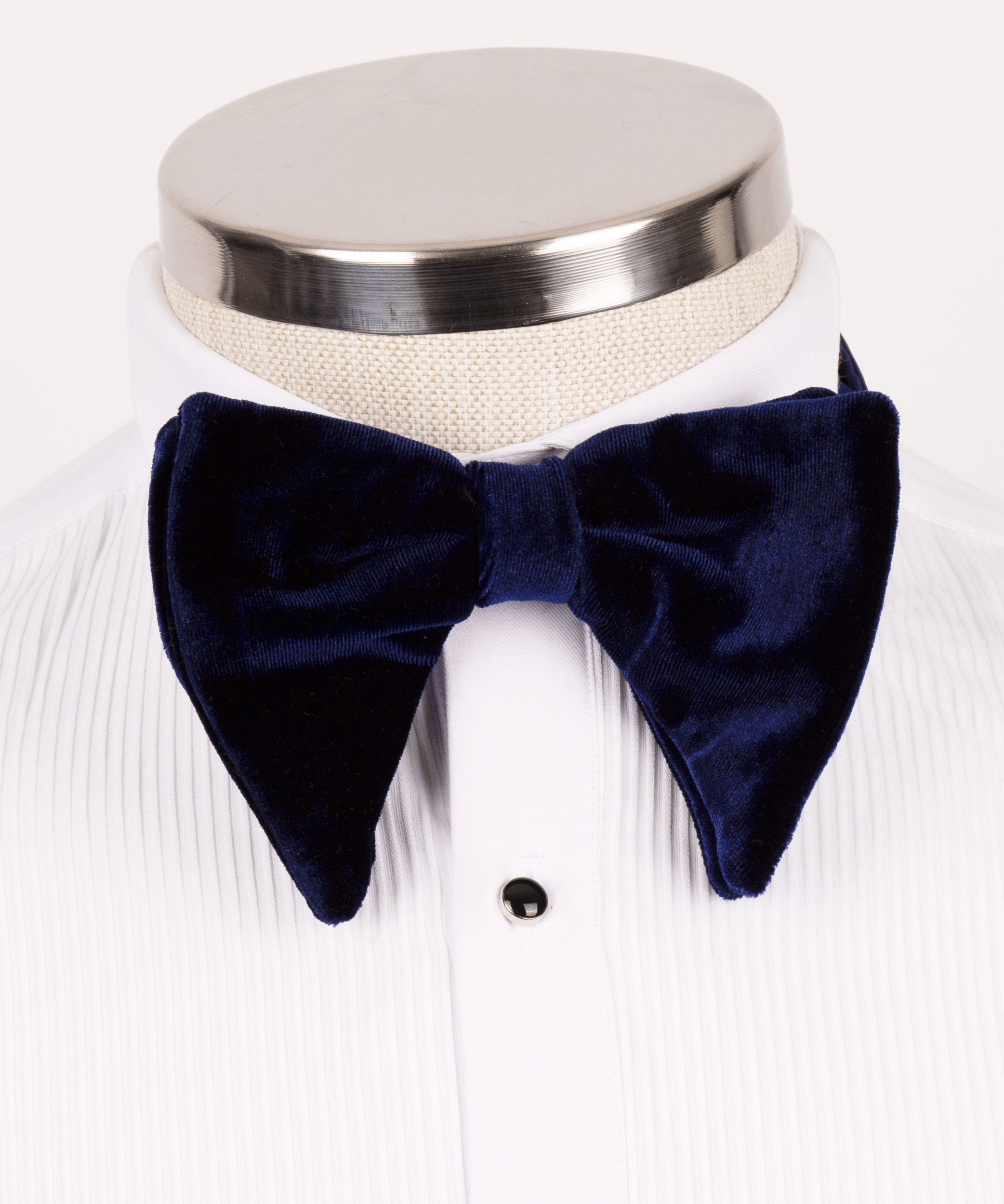 Blue velvet bow tie with self-tie knot on white dress shirt collar