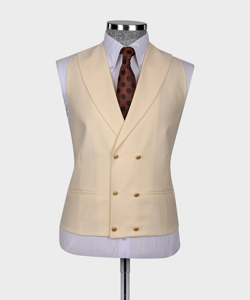 Cream formal waistcoat with gold buttons over white shirt and brown polka-dot tie