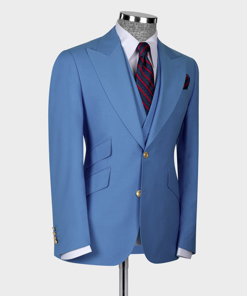 Light blue suit jacket and vest with pocket square and red patterned tie