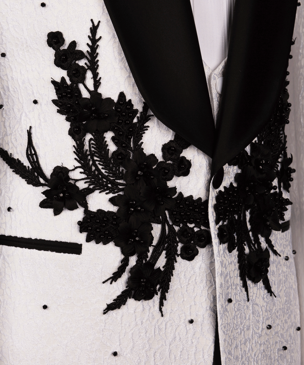 Close-up of black floral appliqué on white tuxedo jacket lapel