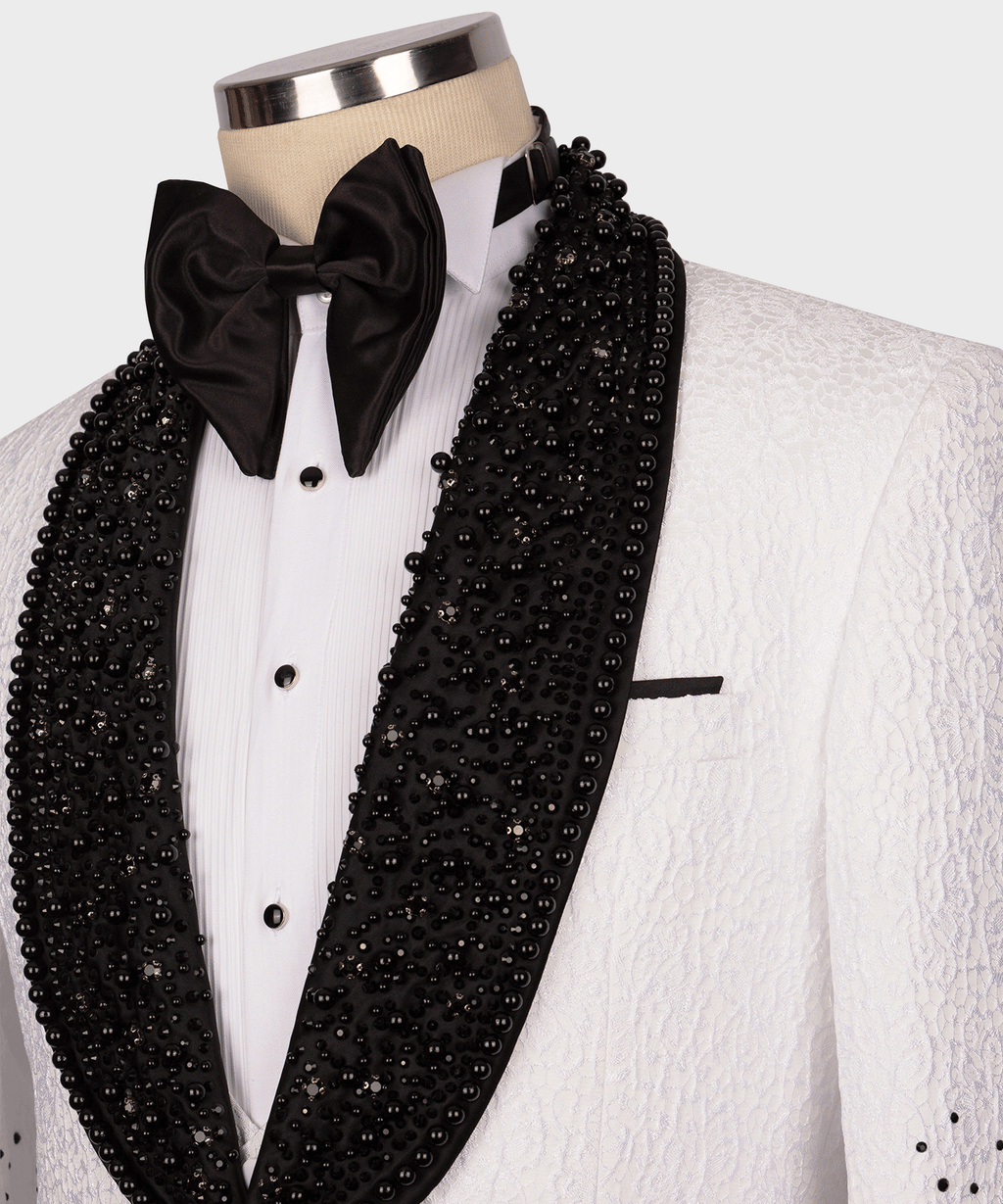 Close-up of black gem-embellished tuxedo lapel with black satin bow tie